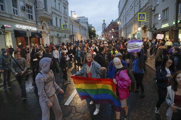 FILE - LGBT activists hold their flag at a rally to collect signatures to cancel the results of voting on amendments to the Constitution in Pushkin Square in Moscow, Russia, Wednesday, July 15, 2020. The Russian Justice Ministry says it has filed a lawsuit with the country's Supreme Court to outlaw the LGBTQ "international public movement" as extremist. (AP Photo, File)