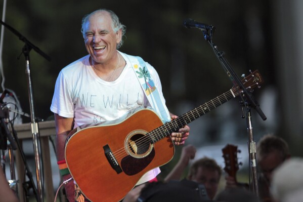 FILE - Jimmy Buffett performs at his sister's restaurant in Gulf Shores, Ala., on June 30, 2010. “Margaritaville” singer-songwriter Jimmy Buffett has died at age 76. A statement on Buffett's official website and social media pages says the singer died Friday, Sept. 1, 2023 “surrounded by his family, friends, music and dogs”. (AP Photo/Dave Martin, File)