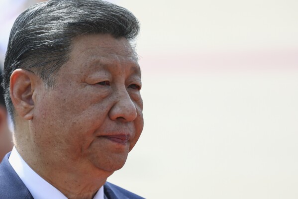Chinese President Xi Jinping reacts as he lays a wreath at the Ho Chi Minh Mausoleum during his visit to Hanoi, Vietnam, Tuesday, April 15, 2025. (Athit Perawongmetha/Pool Photo via AP)