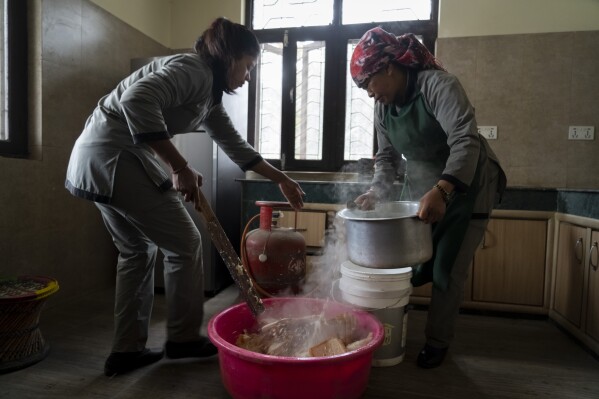 Zoo keepers prepares food for animals at the animal kitchen inside the Central Zoo in Lalitpur, Nepal, on Feb. 21, 2024. The only zoo in Nepal is home to more than 1,100 animals of 114 species, including the Bengal Tiger, Snow Leopard, Red Panda, One-Horned Rhino and the Asian Elephant. (AP Photo/Niranjan Shrestha)