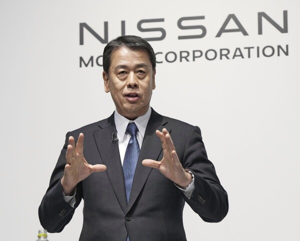 Nissan Chief Executive Makoto Uchida gestures during a joint news conference with Honda President Toshihiro Mibe in Tokyo, Friday, March 15, 2024. Nissan and Honda announced Friday that they will work together in developing electric vehicles and auto intelligence technology, sectors where Japanese automakers have fallen behind. (Kyodo News via AP)