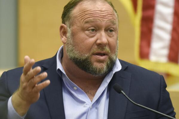 FILE - Conspiracy theorist Alex Jones takes the witness stand to testify at the Sandy Hook defamation damages trial at Connecticut Superior Court in Waterbury, Conn. Thursday, Sept. 22, 2022.  On Friday, Oct. 21, Jones has asked a Connecticut judge to throw out a nearly $1 billion verdict against him and order a new trial in a lawsuit by Sandy Hook families over Jones' lies that the 2012 Newtown school shooting was a hoax.(Tyler Sizemore/Hearst Connecticut Media via AP, Pool, File)