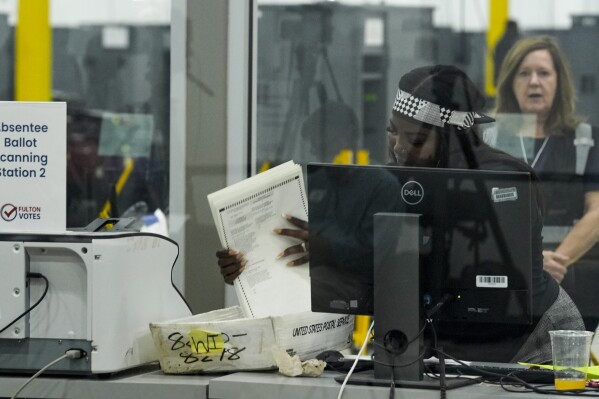 An election staffer works at the Fulton County Election Hub and Operation Center, Tuesday, Nov. 5, 2024, in Atlanta. (AP Photo/John Bazemore, File)