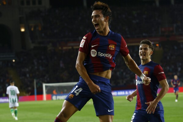 Barcelona's Joao Felix celebrates after scoring his side's first goal during a Spanish La Liga soccer match between Barcelona and Betis at the Olympic Stadium of Montjuic in Barcelona, Spain, Saturday, Sept. 16, 2023. (AP Photo/Joan Monfort)