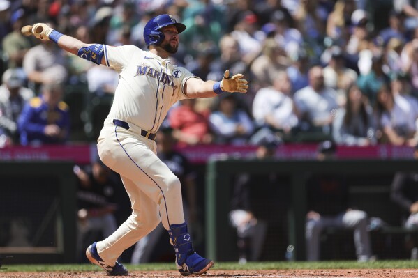 Seattle Mariners' Cal Raleigh watches his solo home run during the seventh inning of a baseball game against the Minnesota Twins, Sunday, Jun 1, 2025, in Seattle. (AP Photo/Ryan Sun)