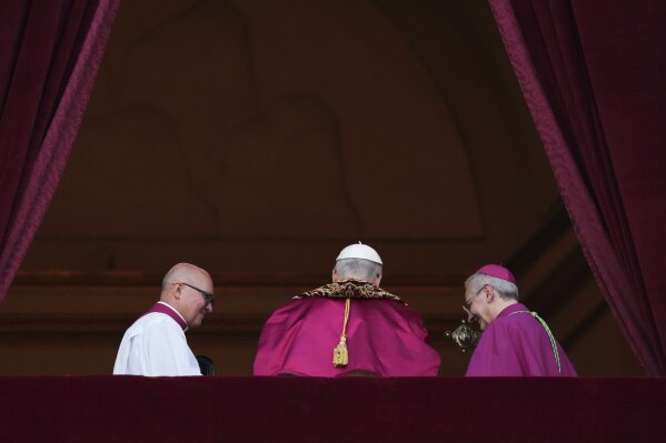 Newly elected Pope Leo XIV leaves the balcony of St. Peter's Basilica after addressing faithful at the Vatican, Thursday, May 8, 2025. (AP Photo/Alessandra Tarantino)