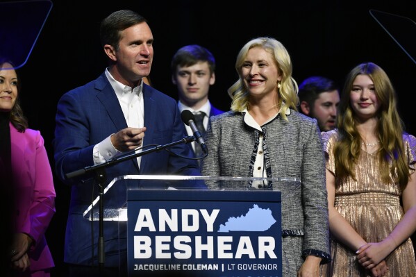 CORRECTS SPELLING OF FIRST NAME TO BRITAINY NOT BRITIANY - Kentucky Gov. Andy Beshear speaks during an election night rally after he was elected to a second term in Louisville, Ky., Tuesday, Nov. 7, 2023. At right is his wife Britainy Beshear. (AP Photo/Timothy D. Easley)