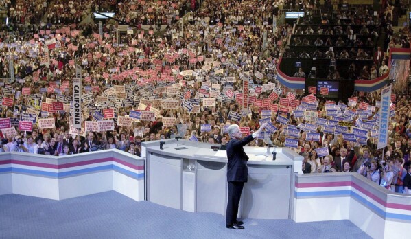 FILE - President Bill Clinton waves to the crowd as he takes the stage to speak at the Democratic National Convention, Aug. 14, 2000 in Los Angeles. (AP Photo/Bob Galbraith, file)