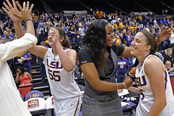 FILE - LSU's Theresa Plaisance (55) walks past as then-LSU assistant coach Tasha Butts celebrates the team's win over Kentucky with guard Jeanne Kenney after an NCAA college basketball game in Baton Rouge, La., Feb. 24, 2013. Long-time college assistant Tasha Butts was hired as head coach of Georgetown's women's basketball team on Tuesday, April 11, 2023. Butts replaces James Howard, whose contract was not renewed last month after four consecutive losing seasons at the school. (AP Photo/Bill Feig, File)