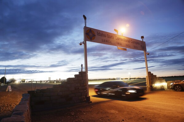 An Idaho State Police vehicle drives under a sign for the Idaho State prison complex near Kuna, Idaho on Wednesday, Feb. 28, 2024. Idaho halted the execution of serial killer Thomas Eugene Creech on Wednesday after medical team members repeatedly failed to find a vein where they could establish an intravenous line to carry out the lethal injection. (AP Photo/Kyle Green)