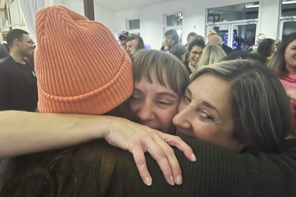 Democrat Susan Gibson, middle, hugs supporters after an announcement that she and fellow Democrats swept the Central Bucks, Pa., school board races on Wednesday, Nov. 8, 2023. (Jason Nark/The Philadelphia Inquirer via AP)