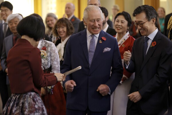 Britain's King Charles III arrives at the New Malden Methodist Church and speaks with Korean Ambassador to the UK, His Excellency Yeocheol Yoon and members of the community groups to hear about Korea's culture and cuisine in New Malden, England, Wednesday, Nov. 8, 2023. (John Phillips/Pool Photo via AP)