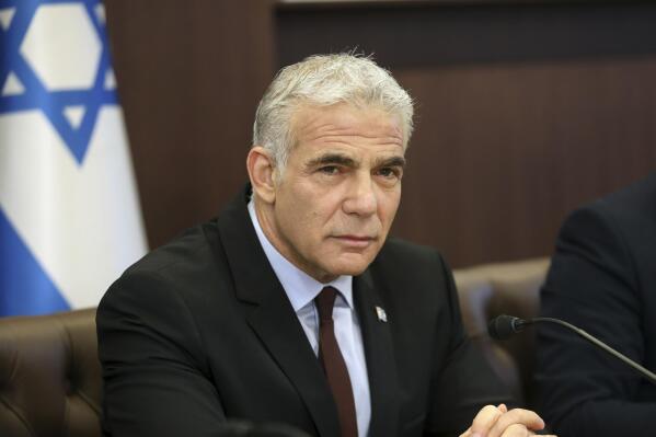 Israel's caretaker Prime Minister Yair Lapid chairs the first cabinet meeting in Jerusalem Sunday, July 3, 2022, days after lawmakers dissolved parliament. (Gil Cohen-Magen/Pool Photo via AP)
