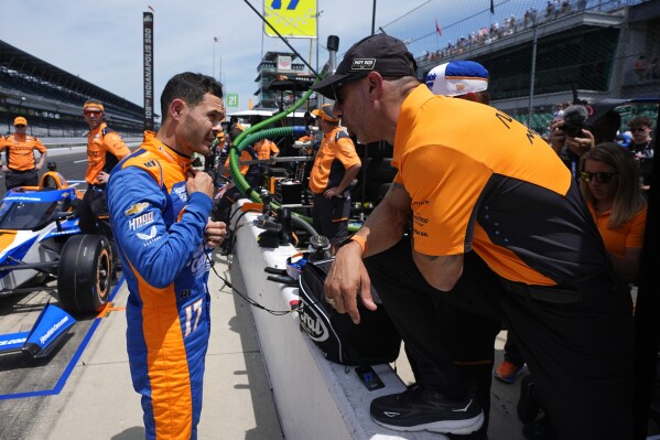 Kyle Larson, left, talks with former Indianapolis 500 champion Tony Kanaan during a practice session for the Indianapolis 500 auto race at Indianapolis Motor Speedway, Monday, May 20, 2024, in Indianapolis. (AP Photo/Darron Cummings)