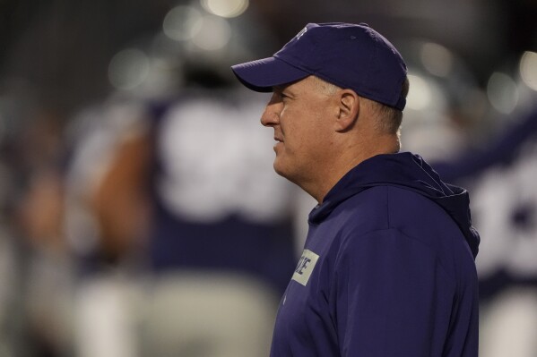 Kansas State head coach Chris Klieman watches his team warm up before an NCAA college football game against Arizona State Saturday, Nov. 16, 2024, in Manhattan, Kan. (AP Photo/Charlie Riedel)