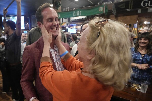 Del. Schuyler VanValkenburg, left, is greeted by a supporter at an election party Tuesday Nov. 7, 2023, in Glenn Allen, Va. (AP Photo/Steve Helber)