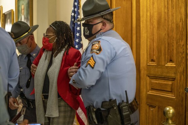 Rep. Park Cannon (D-Atlanta) is placed in handcuffs by Georgia State Troopers after being asked to stop knocking on a door that lead to Gov. Brian Kemp's office while Gov. Kemp was signing SB 202 behind closed doors at the Georgia State Capitol Building in Atlanta, Thursday, March 25, 2021. (Alyssa Pointer/Atlanta Journal-Constitution via AP)