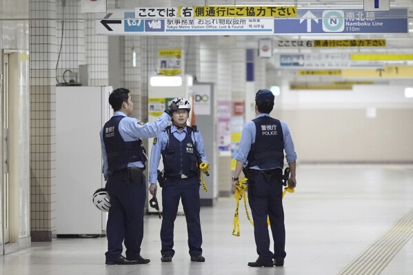 Police officers gather at Todaimae Station where two men were Injured after a knife attack Wednesday, May 7, 2025 in Tokyo. (Kyodo News via AP)