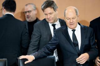 German Chancellor Olaf Scholz, right, and German Economy and Climate Minister Robert Habeck, center, take their seats during weekly cabinet meeting of the German government at the chancellery in Berlin, Germany, Wednesday, Jan. 25, 2023. (AP Photo/Markus Schreiber)