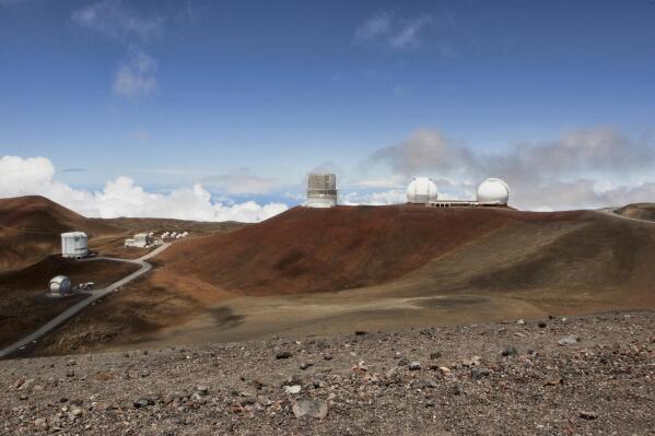 FILE - Telescopes are seen on the summit of Mauna Kea on Hawaii's Big Island, on Aug. 31, 2015. The National Science Foundation said Tuesday, July 19, 2022,  that it plans to conduct a study to evaluate the environmental effects of building the Thirty Meter Telescope, one of the world's largest optical telescopes, on sites selected on Mauna Kea in Hawaii and Spain's Canary Islands. (AP Photo/Caleb Jones, File)
