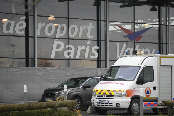 A rescue vehicle is parked outside Vatry Airport in Vatry, eastern France, on Saturday, Dec. 23, 2023.  Nearly 300 Indian nationals bound for Central America remained detained at a French airport for the third day on Saturday amid an investigation into suspected human trafficking, officials said.  The 15 crew members of a Legend Airlines charter flight en route from the United Arab Emirates to Nicaragua were questioned and released, according to a lawyer for the small Romania-based airline.  (AP Photo/Christophe Anna)