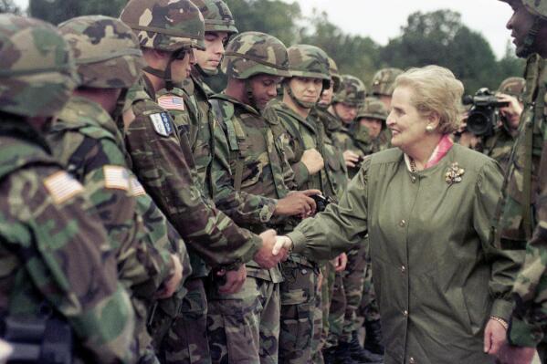 FILE - U.S. Secretary of State Madeleine Albright shakes hands with U..S soldiers during her visit to Air Base Eagle near Tuzla, Aug, 30, 1998. About 6,000 US soldiers are deployed in Tuzla area in a peace keeping mission in Bosnia. Albright has died of cancer, her family said Wednesday, March 23, 2022.(AP Photo/Amel Emric, File)