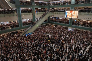 FILE - Local residents sing a theme song written by protesters "Glory be to thee" at a shopping mall in Hong Kong on Sept. 11, 2019. A Hong Kong court rejected Friday, July 28, 2023, a government-requested ban on broadcasting or distributing the protest song “Glory to Hong Kong," in a landmark decision that rejected a challenge to freedom of expression in the city.(AP Photo/Vincent Yu, File)