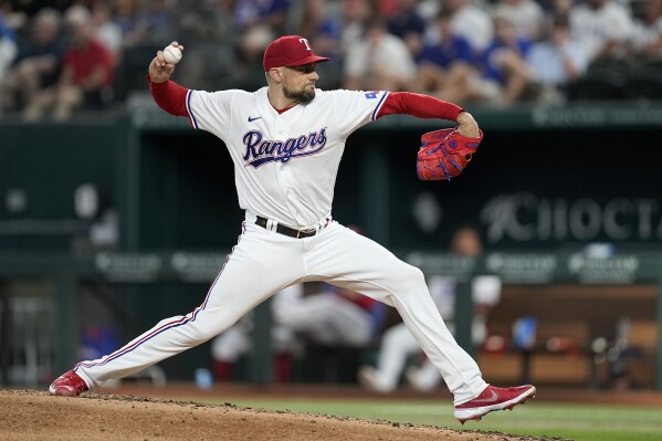 Texas Rangers starting pitcher Nathan Eovaldi throws to a Tampa Bay Rays batter during the third inning of a baseball game Tuesday, July 18, 2023, in Arlington, Texas. (AP Photo/Tony Gutierrez)