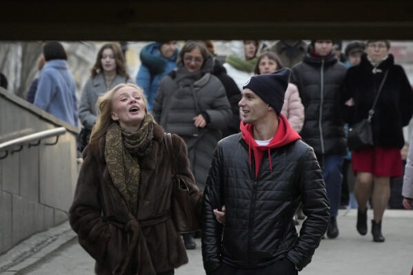 People walk down the street in St. Petersburg, Russia, Monday, Feb. 24, 2025. (AP Photo/Dmitri Lovetsky)