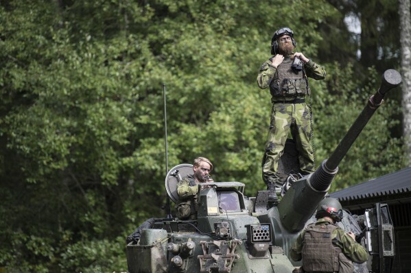 FILE - Swedish soldiers from Skaraborg's Swedish regiments take part in a training exercise as part of the preparations for Aurora 17 field exercise, in Skovde, Sweden, on Sept. 14, 2017. The Swedish government said Monday Sept. 11, 2023 it wants to increase its defense budget by 28%, putting it on track to reach the spending target 2% of gross domestic product set by the NATO alliance, which the Scandinavian country is preparing to join. (Bjorn Larsson Rosvall/TT News Agency via AP, File)