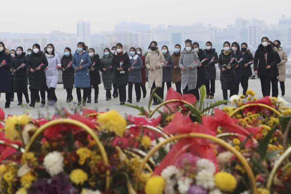 FILE - North Koreans visit and pay respect to the statues of late leaders Kim Il Sung and Kim Jong Il on Mansu Hill in Pyongyang, North Korea, on, Jan. 22, 2023, on the occasion of the Lunar New Year. Russia’s embassy in North Korea says the country has eased stringent epidemic controls in capital Pyongyang that were placed during the past five days to slow the spread of respiratory illnesses. (AP Photo/Cha Song Ho, File)