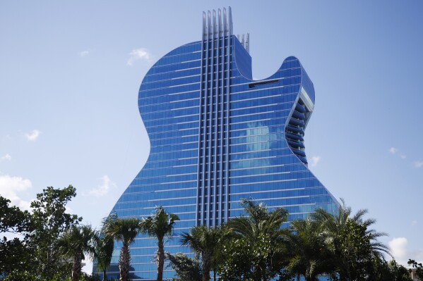 FILE - The guitar shaped hotel is seen at the Seminole Hard Rock Hotel and Casino on Thursday, Oct. 24, 2019, in Hollywood, Fla. The state of Florida and the Seminole Tribe of Florida will be raking in hundreds of millions of dollars from online sports betting this decade, thanks to a compact between the tribe and Gov. Ron DeSantis that gave the tribe exclusive rights to run sports wagers as well as casino gambling on its reservations. (AP Photo/Brynn Anderson, File)