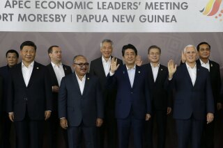 
              FILE - In this Nov. 18, 2018, file photo, Chinese President Xi Jinping, left, and U.S. Mike Pence, right, stand with other APEC leaders during the Economic Leaders Meeting in Port Moresby, Papua New Guinea. All the usual rituals of international summits were there _ the group photos, the gala dinners, the noticeably vibrant shirts leaders are asked to wear. But eclipsing all of that at two recent meetings was some unusually forthright criticism that exposed deepening divisions rattling the Asia-Pacific region.  The disharmony largely centered on the U.S. and China, who are locked in a widening trade war and whose representatives used the summits to exchange barbs with one another and maneuver to expand their influence. (AP Photo/Aaron Favila, File)
            