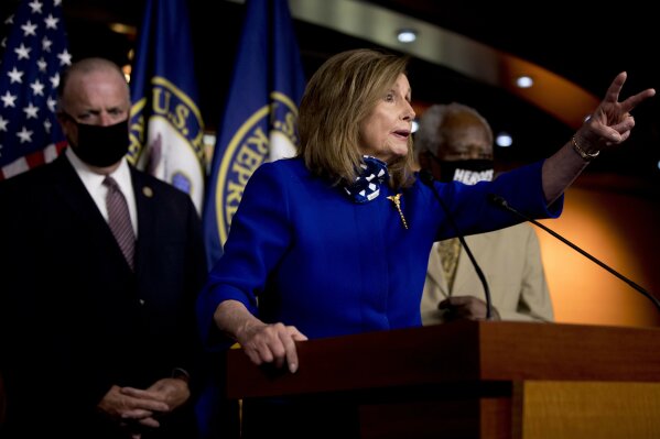 House Speaker Nancy Pelosi of Calif., accompanied by Rep. Dan Kildee, D-Mich., left, and Rep. Danny Davis, D-Ill., right, speaks at a news conference on Capitol Hill in Washington, Friday, July 24, 2020, on the extension of federal unemployment benefits. (AP Photo/Andrew Harnik)