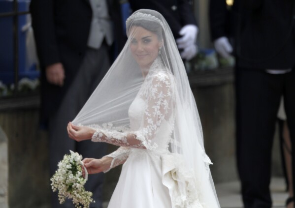 FILE - Kate Middleton arrives for her wedding with Britain's Prince William at Westminster Abbey at the Royal Wedding in London Friday, April 29, 2011. Attention on Princess Kate has reached levels not seen since she married Prince William in a fairy-tale wedding in 2011. An admission from Kate that she altered an official family photo triggered a backlash. (AP Photo/Gero Breloer, File)