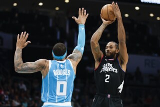 Los Angeles Clippers forward Kawhi Leonard (2) shoots over Charlotte Hornets forward Miles Bridges (0) during the first half of an NBA basketball game in Charlotte, N.C., Sunday, March 31, 2024. (AP Photo/Nell Redmond)