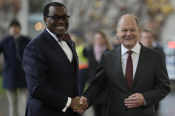 German Chancellor Olaf Scholz, right, welcomes African Development Bank President Akinwumi Adesina at the G20 Investment Summit - German Business and the CwA Countries on the sidelines of a Compact with Africa in Berlin, Germany, Monday, Nov. 20, 2023. In the high-level conference investment summit the African Compact partner countries meet with high-ranking representatives of German companies to explore investments under the framework of the G20 partnership with Africa. (AP Photo/Markus Schreiber)