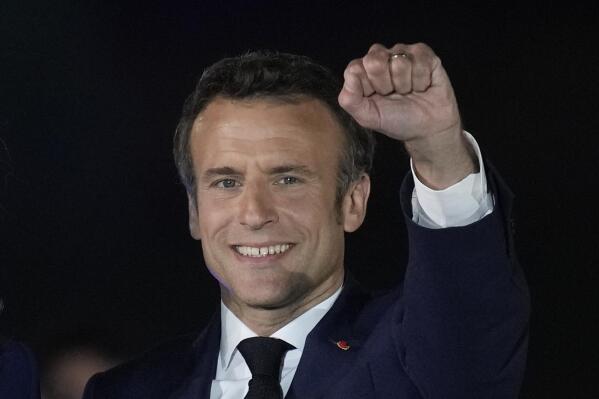 FILE - French President Emmanuel Macron celebrates with his supporters in Paris, France, Sunday, April 24, 2022. After winning another five years in the French presidential palace, Emmanuel Macron intends to go back to work straightaway on domestic and foreign policy — but he will soon face crucial parliamentary elections where he may struggle to keep his majority. (AP Photo/Christophe Ena, File)