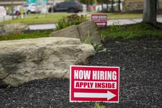 This May 5, 2021 photo shows hiring signs posted outside a gas station in Cranberry Township, Butler County, Pa. The number of Americans applying for unemployment benefits dropped last week,  reported Thursday, June 24, a sign that layoffs declined and the job market is improving.  (AP Photo/Keith Srakocic)