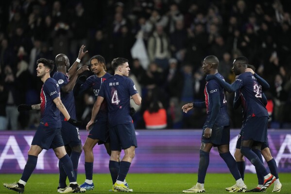 PSG's team players celebrate after Randal Kolo Muani scored his side's third goal during the French League One soccer match between Paris Saint-Germain and Lille at the Parc des Princes stadium in Paris, France, Saturday, Feb. 10, 2024. (AP Photo/Thibault Camus)