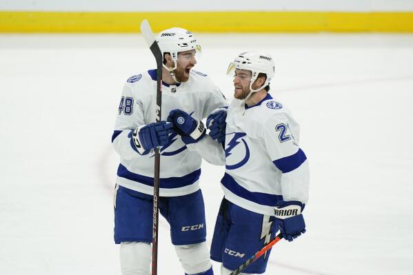 Tampa Bay Lightning center Brayden Point (21) celebrates his goal with defenseman Nick Perbix (48) during the third period of an NHL hockey game against the Florida Panthers, Friday, Oct. 21, 2022, in Sunrise, Fla. (AP Photo/Wilfredo Lee )