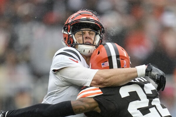 Cincinnati Bengals quarterback Joe Burrow, left, is hit by Cleveland Browns safety Grant Delpit, right, as he throws during the second half of an NFL football game Sunday, Sept. 10, 2023, in Cleveland. (AP Photo/Sue Ogrocki)