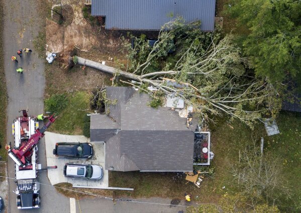 An aerial photography shows the house where two victims were recovered after a tree landed on the home in the 500 block of Garner Street in Buford, Ga. Thursday, Oct. 29, 2020. Two adults were found dead in their bed Thursday afternoon in Gwinnett County after a tree landed on their home, according to police and firefighters. (Hyosub Shin/Atlanta Journal-Constitution via AP)