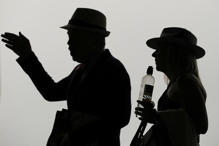 Race fans walk though the stands Churchill Downs before the 150th running of the Kentucky Derby horse race Saturday, May 4, 2024, in Louisville, Ky. (AP Photo/Charlie Riedel)