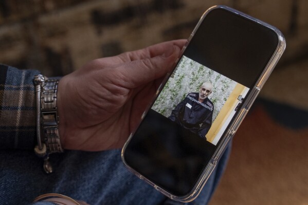 Oksana Hryhorieva of Pyriatyn, Ukraine, shows a video of her father, Serhii Hryhoriev, from when he was a prisoner of war in Russia, March 9, 2025. (AP Photo/Alex Babenko)