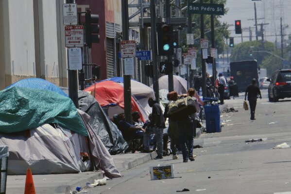FILE - In this May 30, 2019 file photo, tents housing homeless line a street in downtown Los Angeles. A proposed California ballot measure would require counties to set up special courts that send homeless people to mental health and drug treatment programs. It needs more than 600,000 signatures to qualify for the state ballot. (AP Photo/Richard Vogel, File)