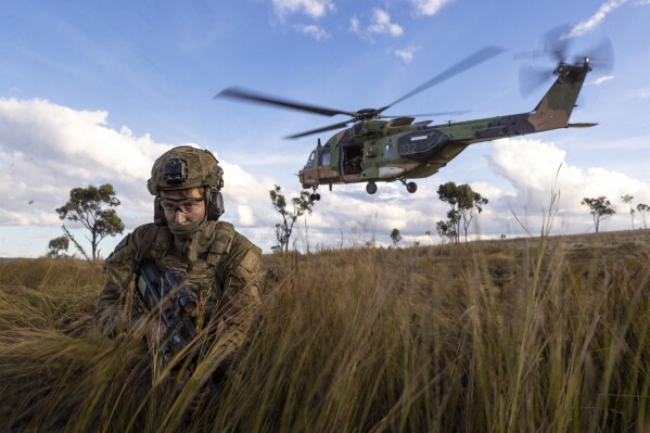 In this photo provided by the Australian Defense Force, soldiers from the 4th Regiment, Royal Australian Artillery and 3rd Battalion dismount from an MRH-90 Taipan during Exercise Chau Pha at Townsville Field Training Area, Townsville, Queensland, on June 12, 2023. The Australian army will never again fly its fleet of MRH-90 Taipan helicopters following a crash in July that killed four personnel, the defense minister said on Friday, Sept. 29, 2023. (LCPL Riley Blennerhassett/ADF via AP)