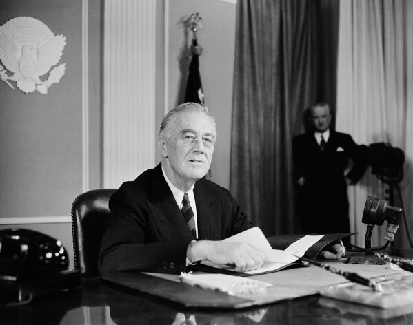 FILE - In this Nov. 19, 1944, file photo, President Franklin D. Roosevelt speaks before a nationwide audience from the East Room of the White House in Washington, on the eve of the Sixth War Loan campaign, to urge the people to buy more war bonds. He declared the war is costing $250,000,000 a day. (AP Photo/Henry Burroughs, File)