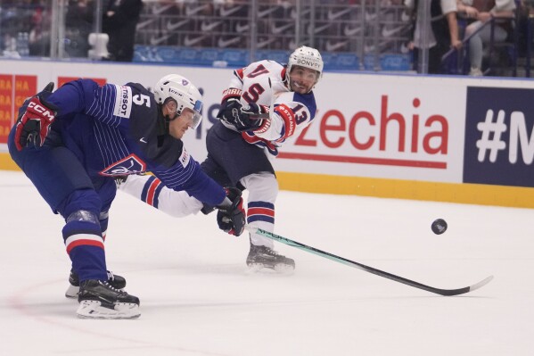 Unted States' Johnny Gaudreau, right, tries to score as France's Enzo Guebey blocks him during the preliminary round match between United States and France at the Ice Hockey World Championships in Ostrava, Czech Republic, Thursday, May 16, 2024. (AP Photo/Darko Vojinovic)