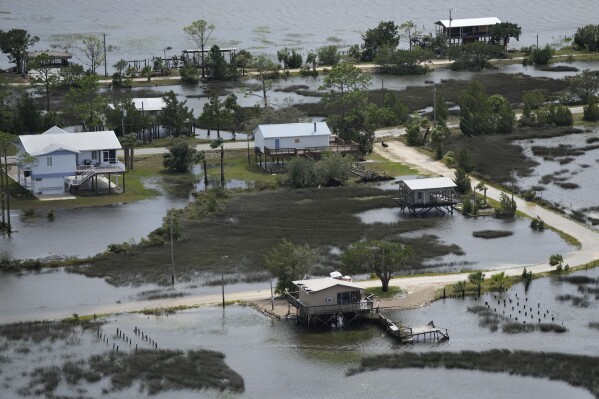 In this photo made in a flight provided by mediccorps.org, receding storm waters surround homes in Keaton Beach, Fla., following the passage of Hurricane Idalia, Wednesday, Aug. 30, 2023. (AP Photo/Rebecca Blackwell)